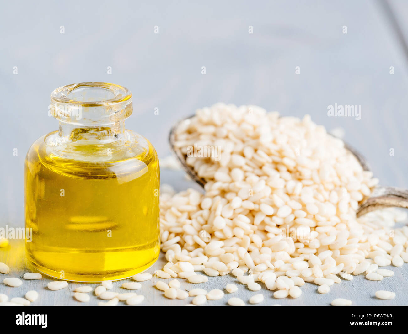 Bottle of sesame oil and sesame seeds Stock Photo