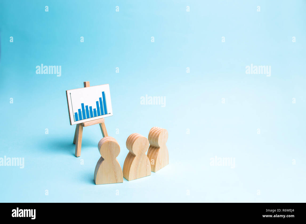 Three people look at the schedule and discuss business strategy and
