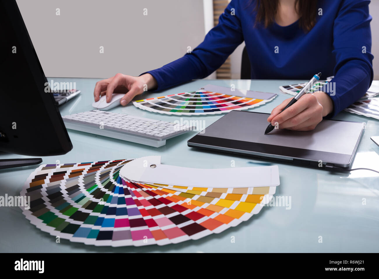 Designer's Hand Drawing On Graphic Tablet Stock Photo
