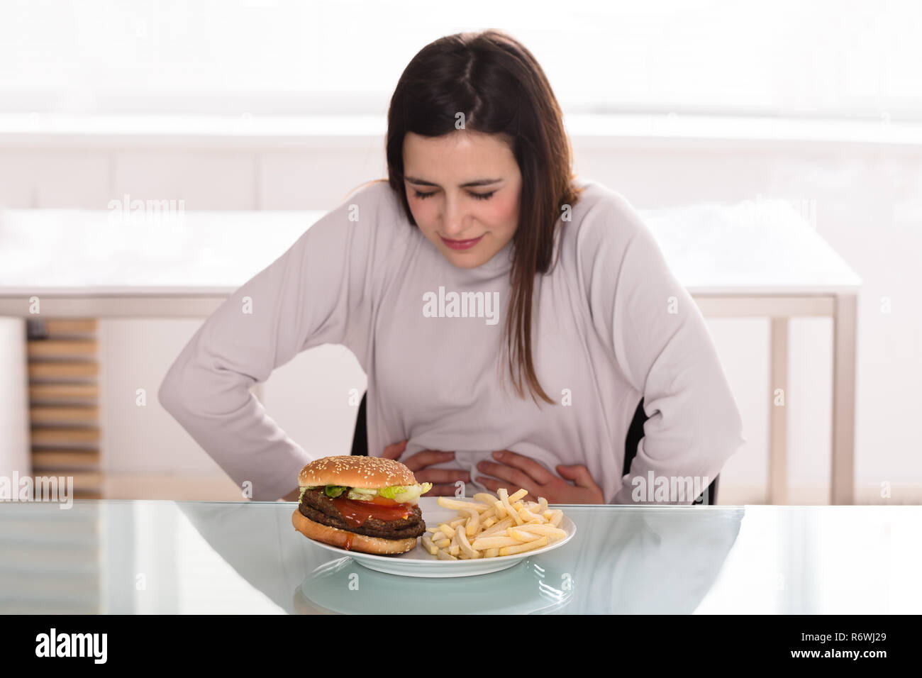 Young Woman Suffering From Stomach Pain Stock Photo