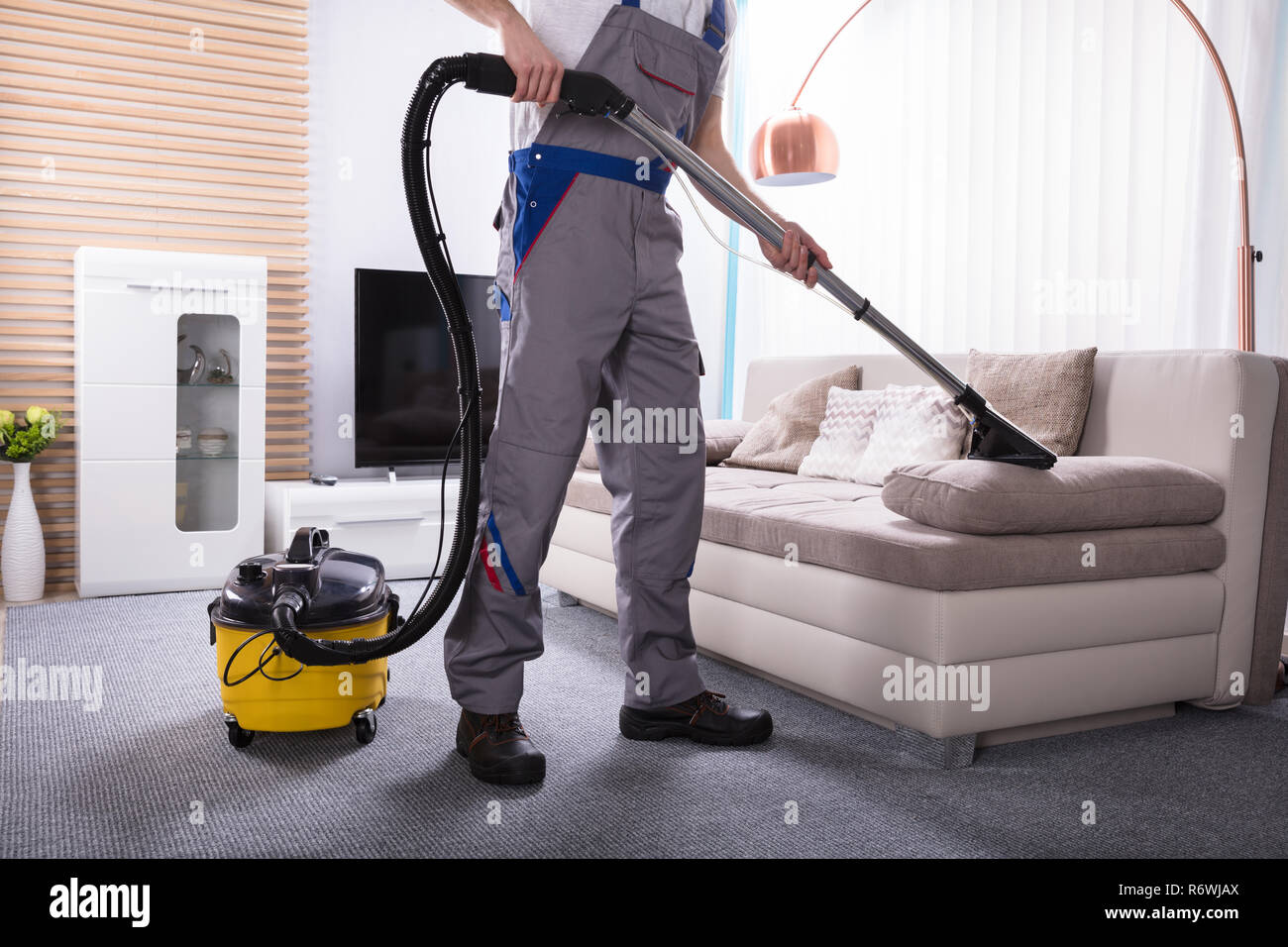 Person Cleaning Sofa With Vacuum Cleaner Stock Photo Alamy
