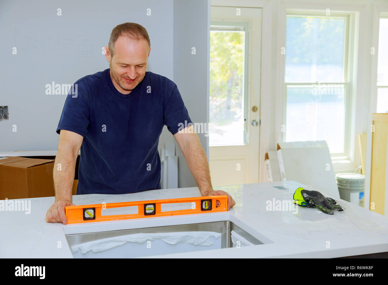 Workers are installing top counter kitchen Stock Photo Alamy