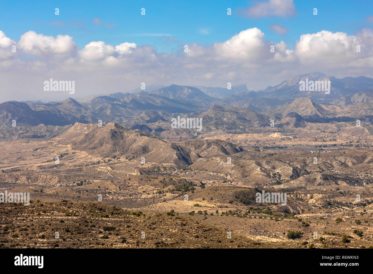 mountain landscape of alicante, mountains without vegetation and eroded under a blue sky Stock Photo