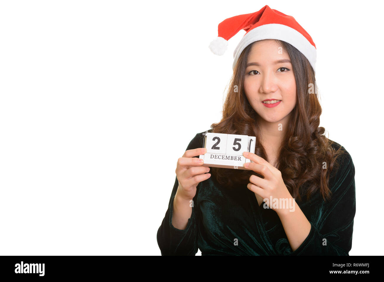 Young happy Asian woman holding calendar with 25th December read Stock Photo