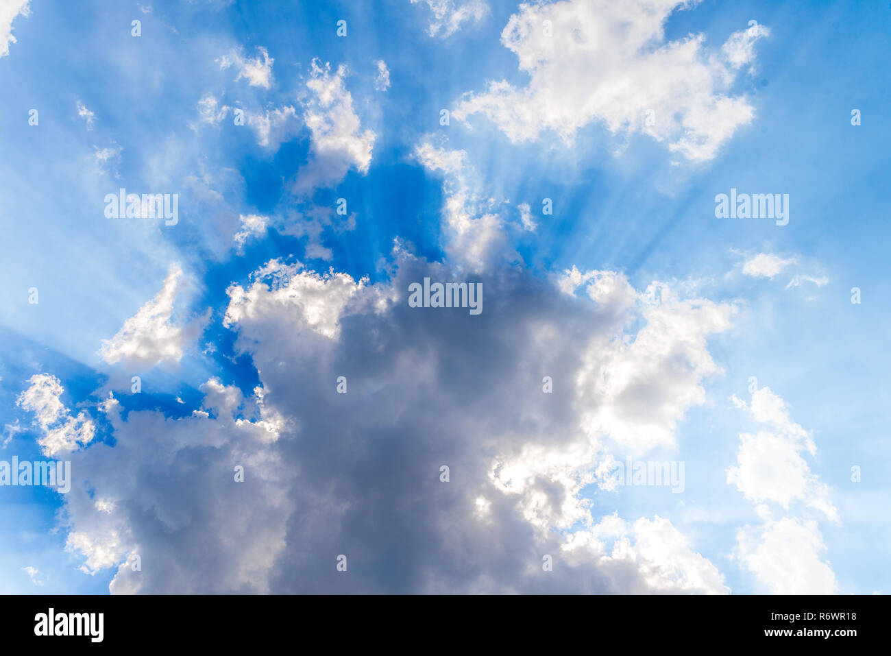 White clouds and sunrays on blue sky Stock Photo