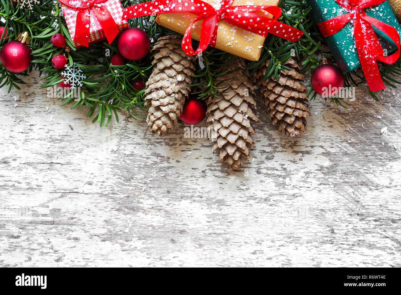 Christmas background with fir tree branches, decorations and gift boxes ...