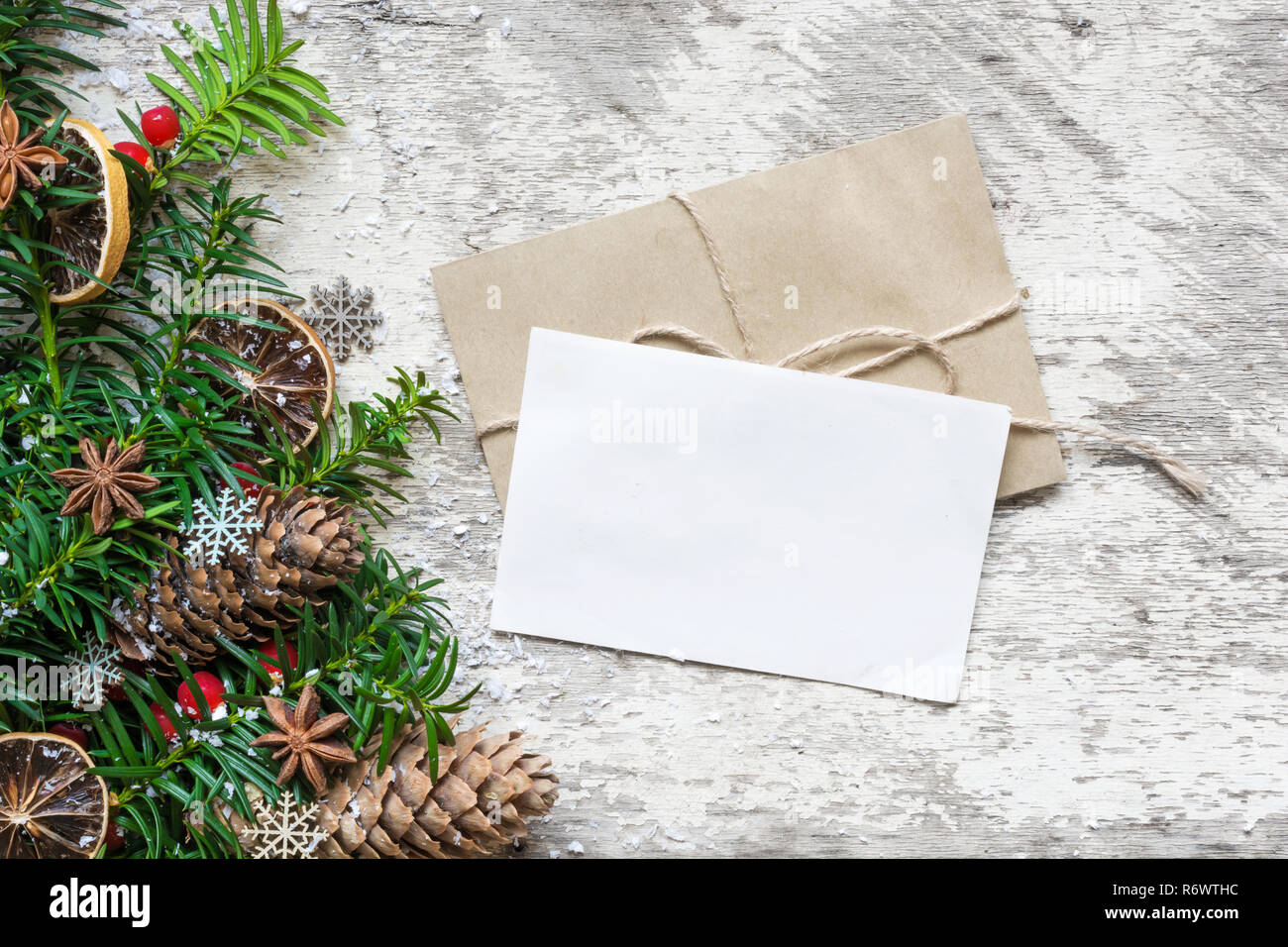 blank white christmas greeting card and envelope with fir tree branches ...