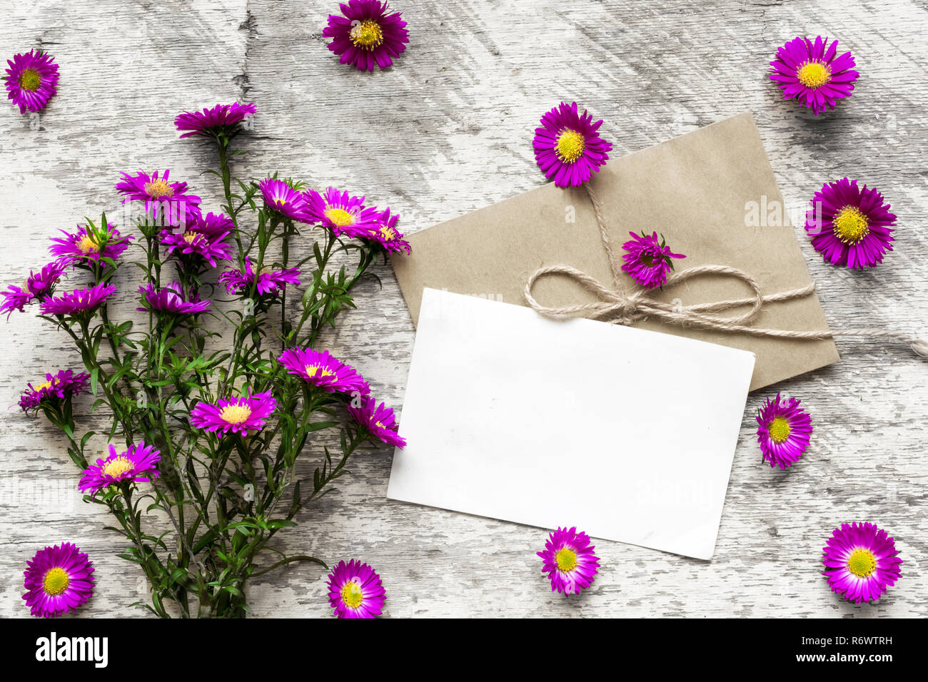 blank white greeting card with pink flowers bouquet and envelope on ...