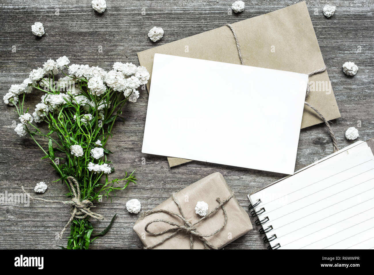 blank white greeting card with white flowers bouquet and envelope with ...