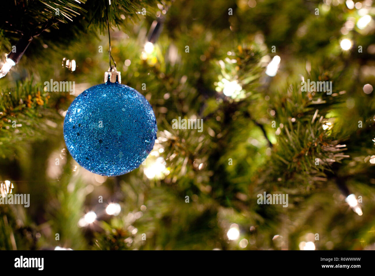 Blue Christmas Ornament on Tree with Lights Stock Photo - Alamy