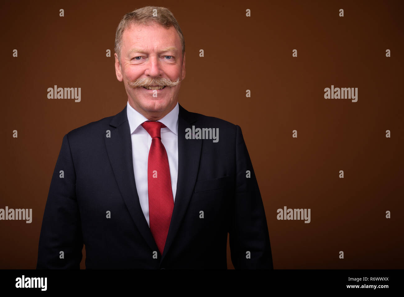 Happy senior businessman wearing suit and tie while smiling Stock Photo ...