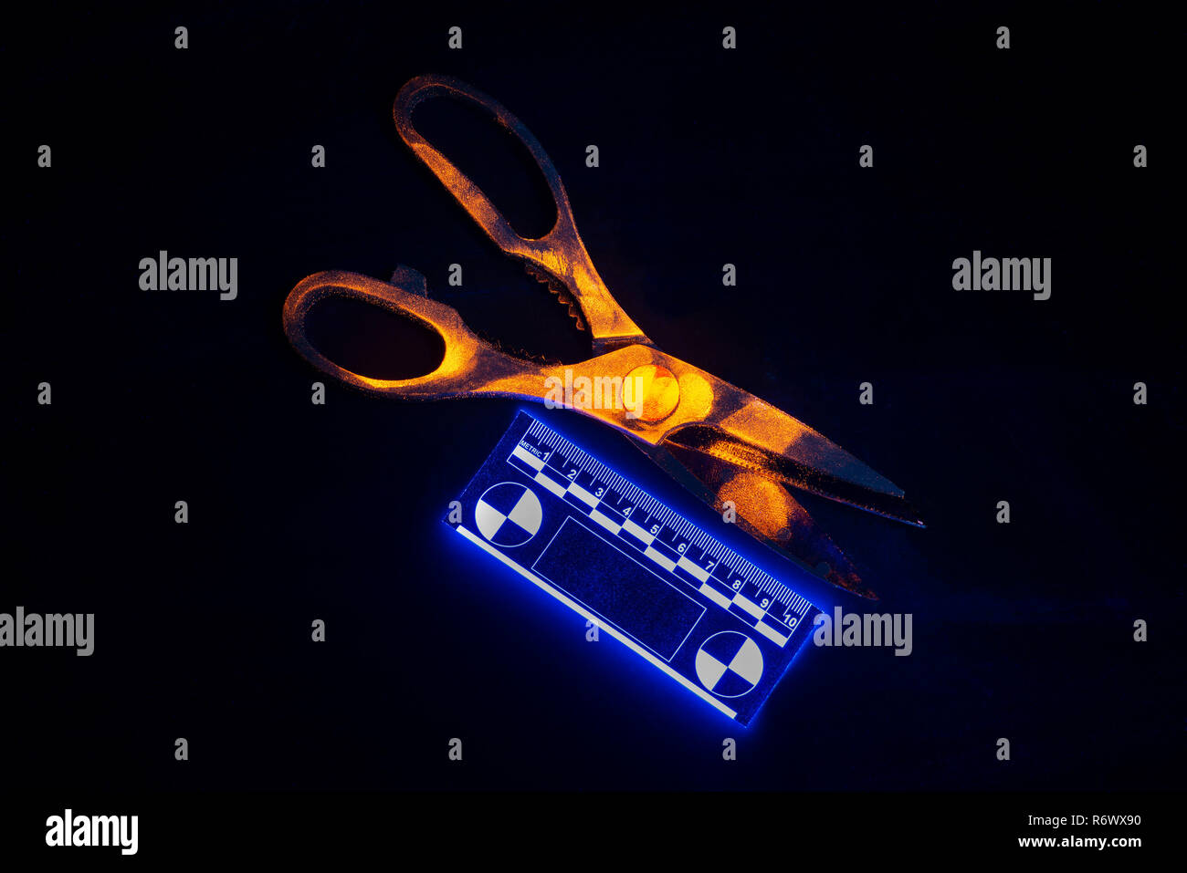 Difficult to seen under daylight, fingerprints on scissors glow orange