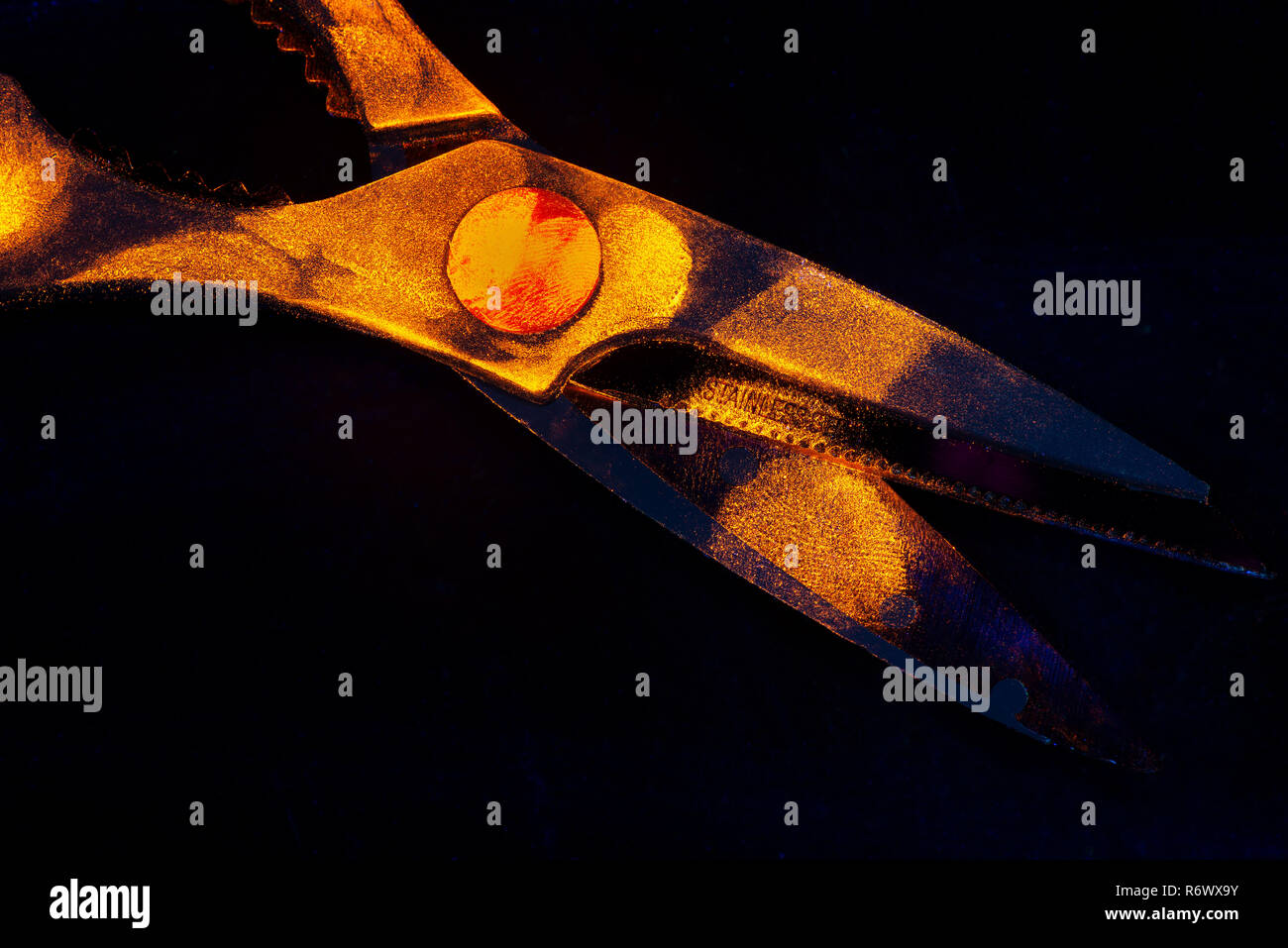 Difficult to seen under daylight, fingerprints on scissors glow orange