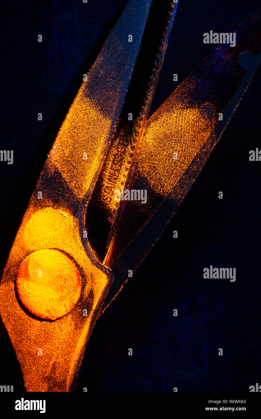 Difficult to seen under daylight, fingerprints on scissors glow orange