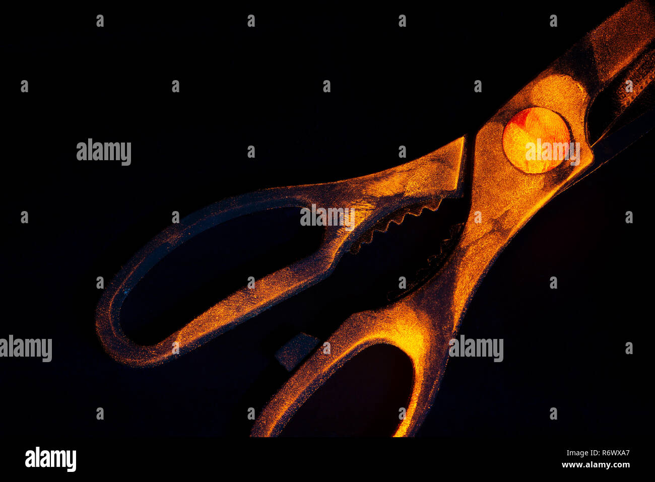 Difficult to seen under daylight, fingerprints on scissors glow orange