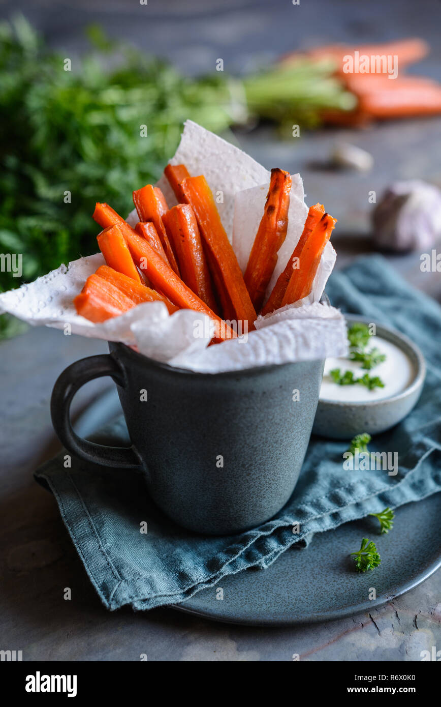 Vegan carrot fries with sour cream and garlic dip Stock Photo Alamy