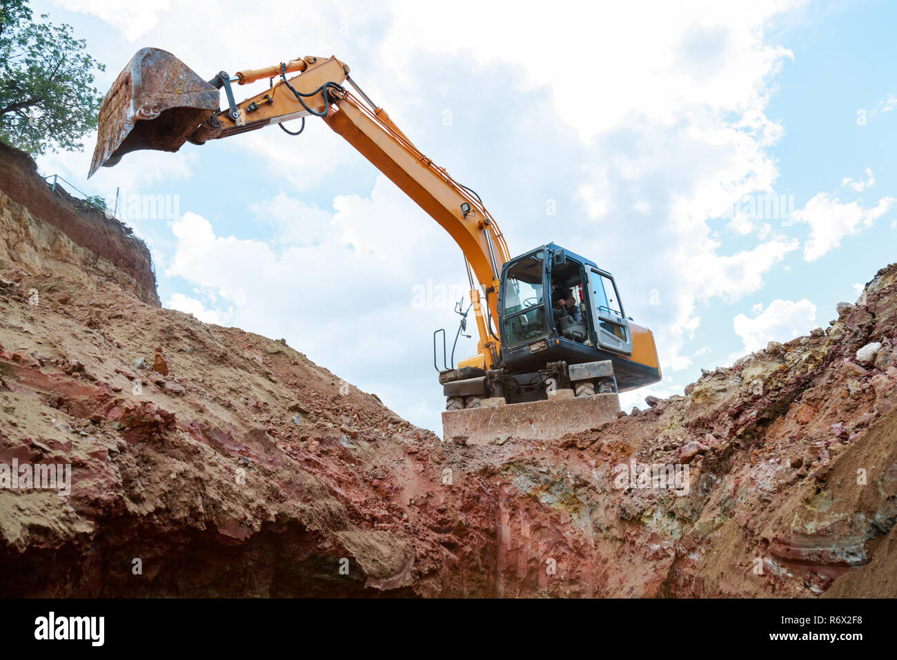 Excavator digging a trench for the pipeline. Excavation Stock Photo