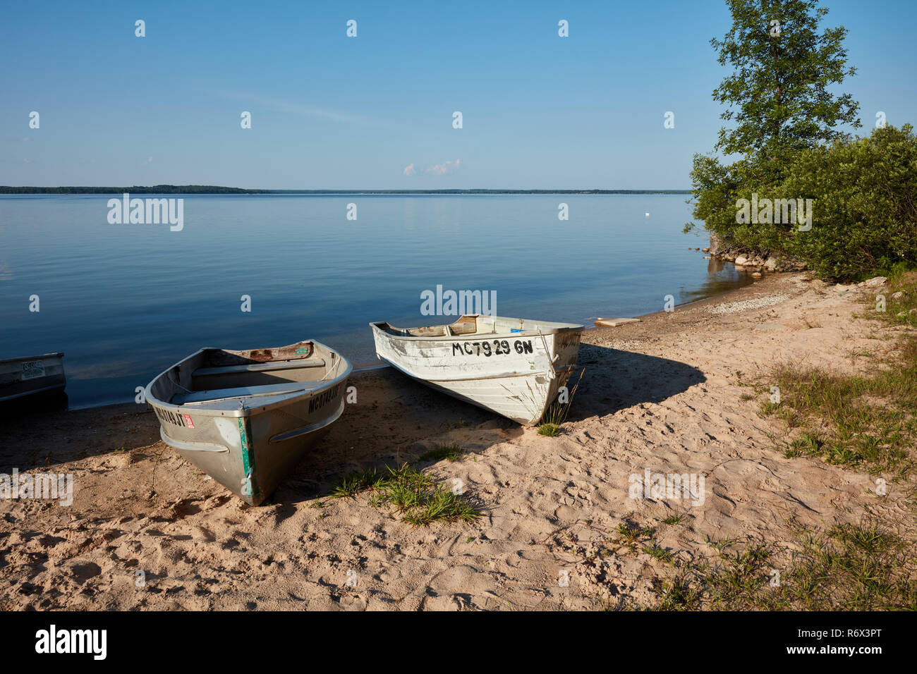 Two small fishing boats on the beach of Manistique Lake in Michigan's upper peninsual Stock