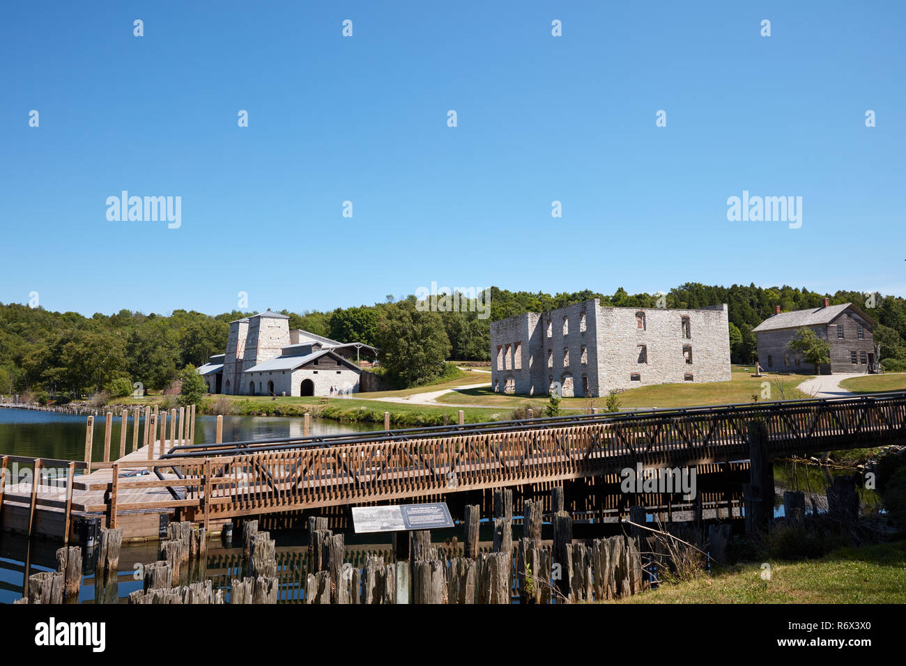 Modern docks with the ruins of the furnace and company store buildings in the background at Fayette Historic State Park, Michigan Stock Photo