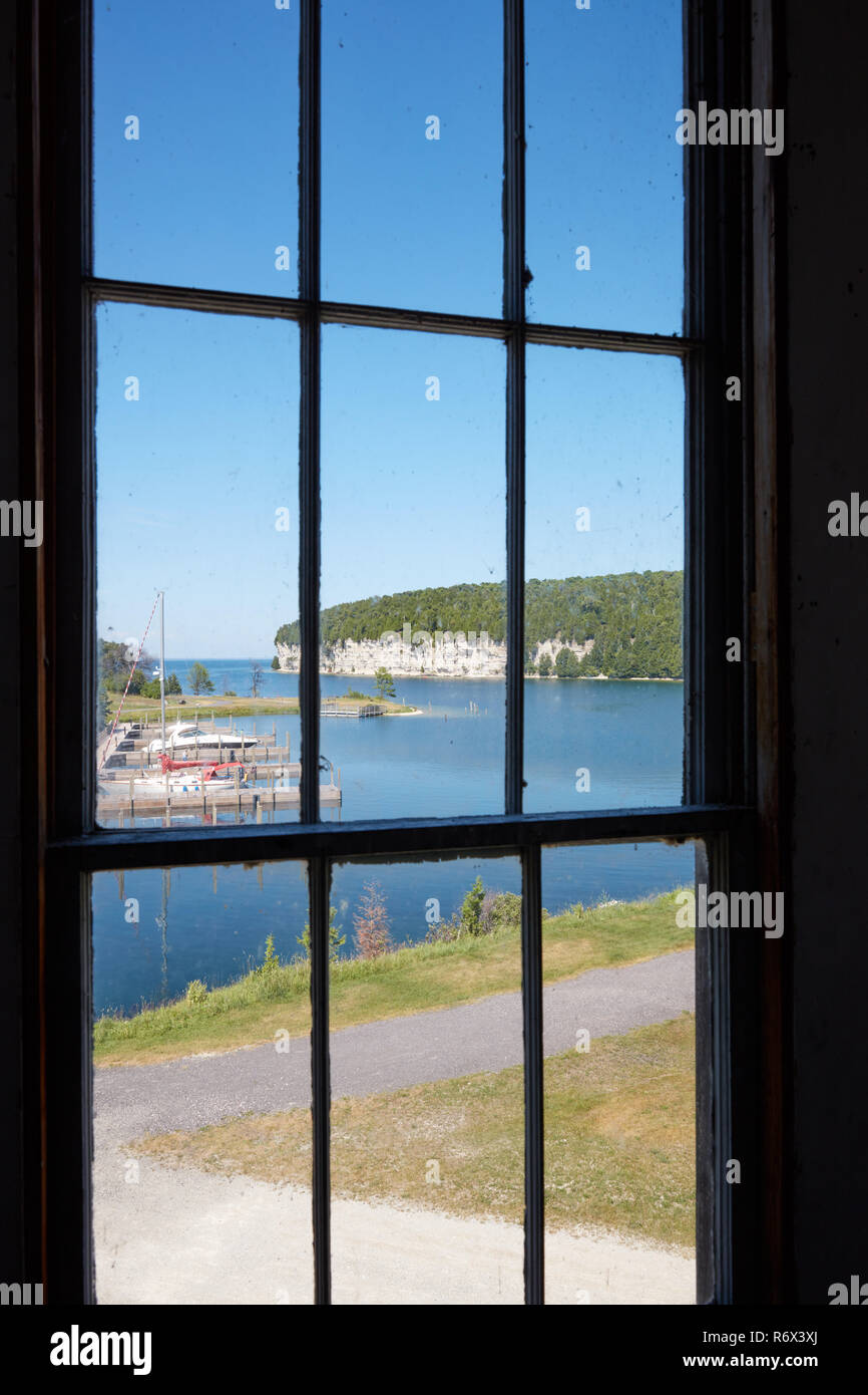 A view of the harbor from a window of the Music hall in the historic ghost town of Fayette, Michigan Stock Photo