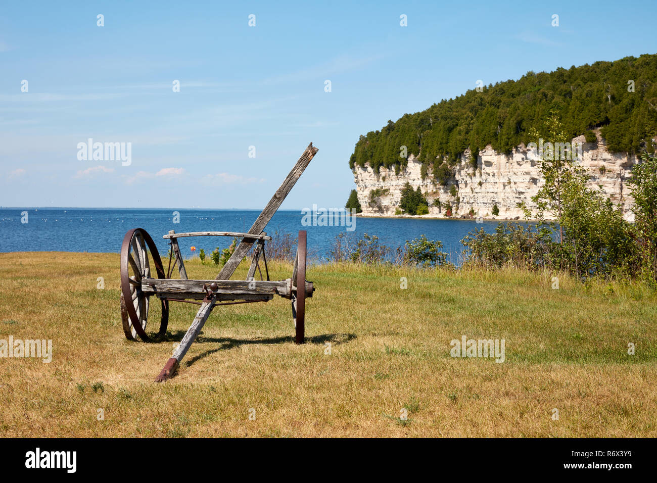 Remains of a horse drawn wagon overlooking the harbor at the historic ghost town of Fayette, Michigan Stock Photo