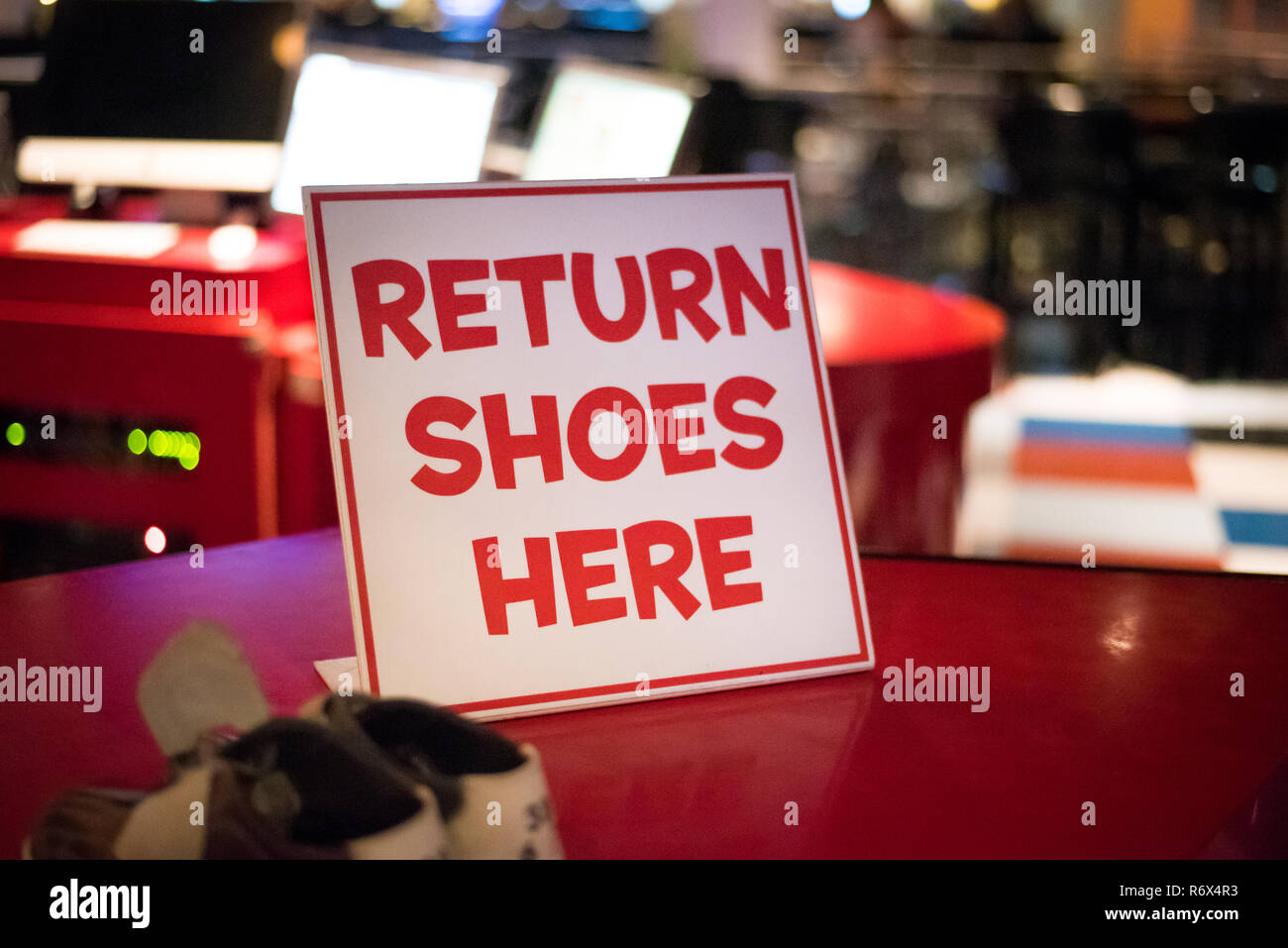Return Shoes Here sign at bowling alley Stock Photo Alamy