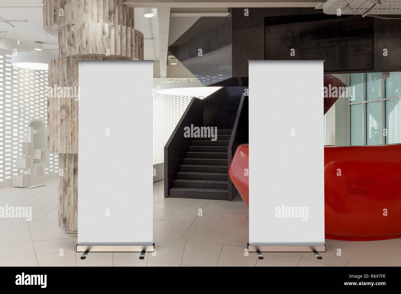 Two Blank Roll Up Banner Stand In Office Interior With Reception