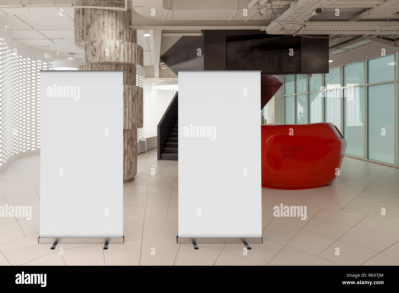Two Blank Roll Up Banner Stand In Office Interior With Reception