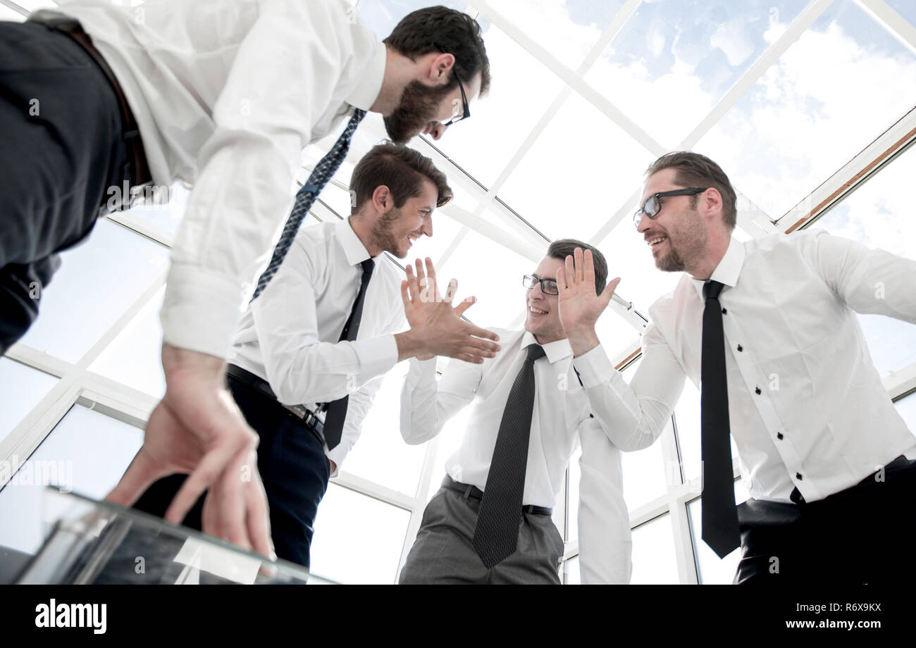 bottom view.happy business team standing near the negotiating ta Stock Photo