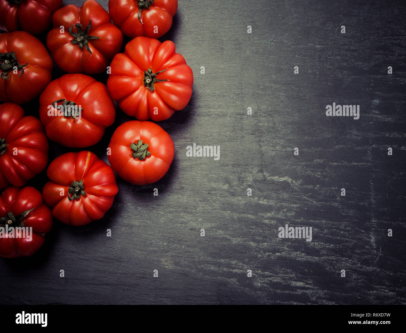 Marmande tomatoes on slate background Stock Photo