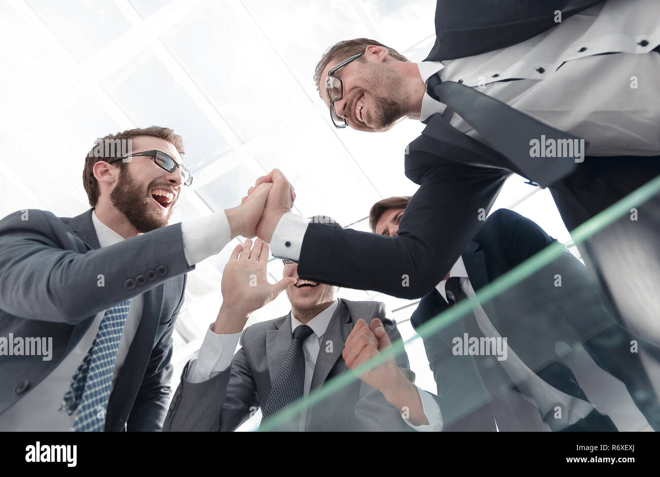 bottom view.happy business team standing near office Desk Stock Photo ...