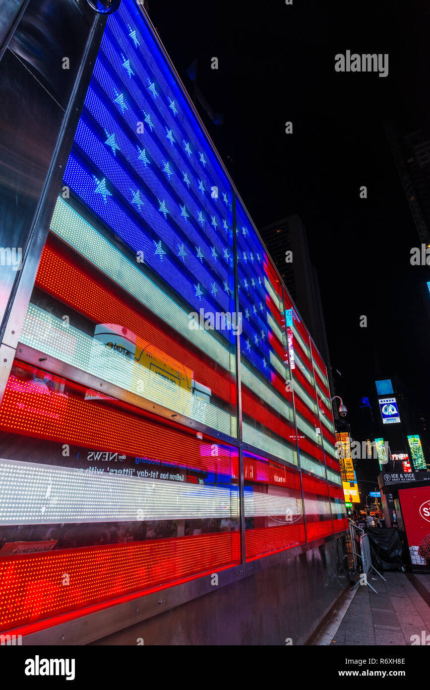 New York City, USA - July 30, 2018: US Army Recruitment Center on Times Square at night with a large flag and advertising screens in Manhattan in New  Stock Photo