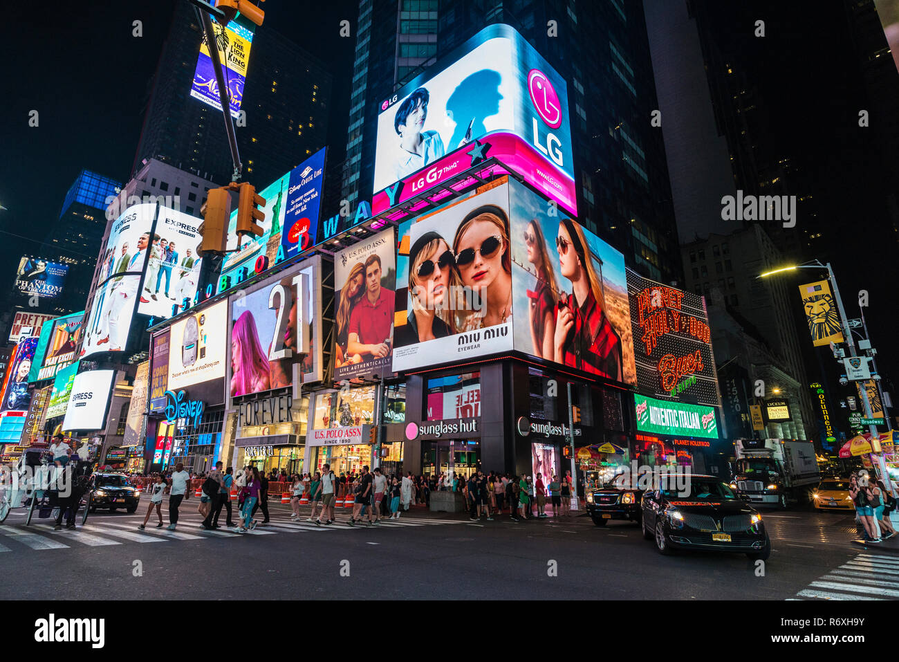 New York City, USA - July 30, 2018: Times Square at night with people around and large advertising screens in Manhattan in New York City, USA Stock Photo