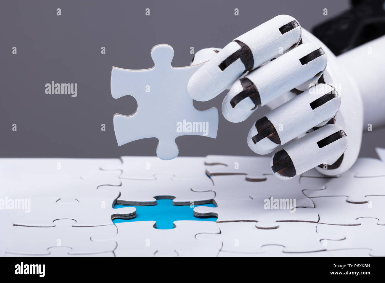Robot Solving Jigsaw Puzzle Stock Photo