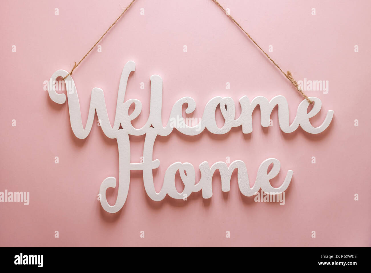 welcome home white words pink background Stock Photo - Alamy