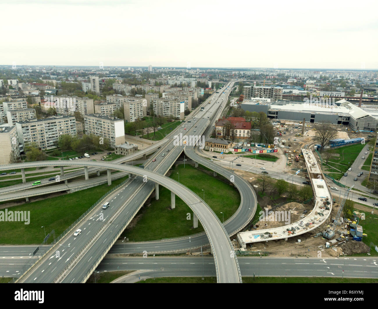 Aerial highway junction. Highway from aerial view. Urban highway and lifestyle concept. Construction of additional concrete road curve of viaduct in Riga, Latvia Stock Photo