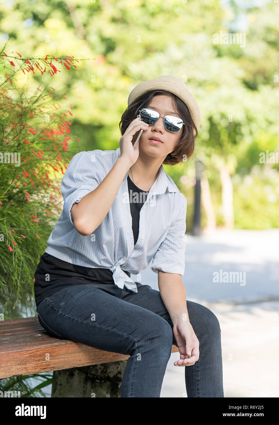 Women With Short Hair Wearing Hat In Garden Stock Photo 228017501