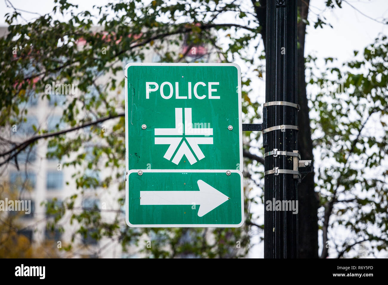 MONTREAL, CANADA - NOVEMBER 5, 2018: Roadsign indicating the nearest Montreal Police station with its official logo. It is the Police Department of th Stock Photo