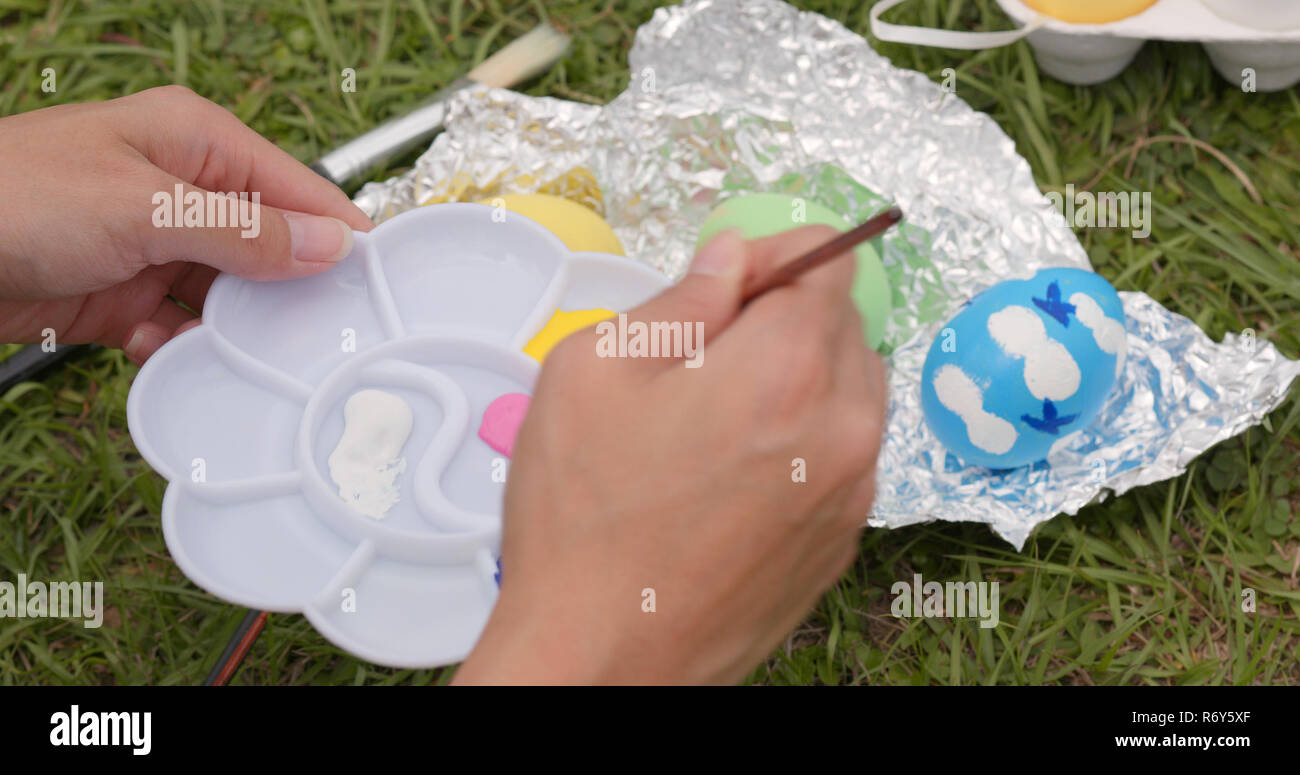 Painting on chicken egg for Easter holiday Stock Photo