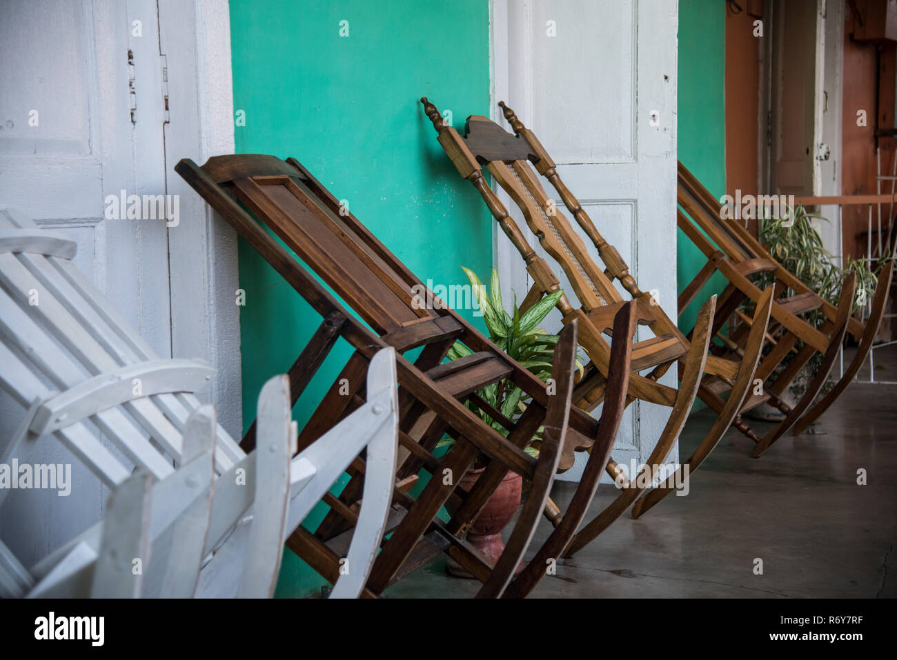Rocking chairs propped against a wall Stock Photo Alamy