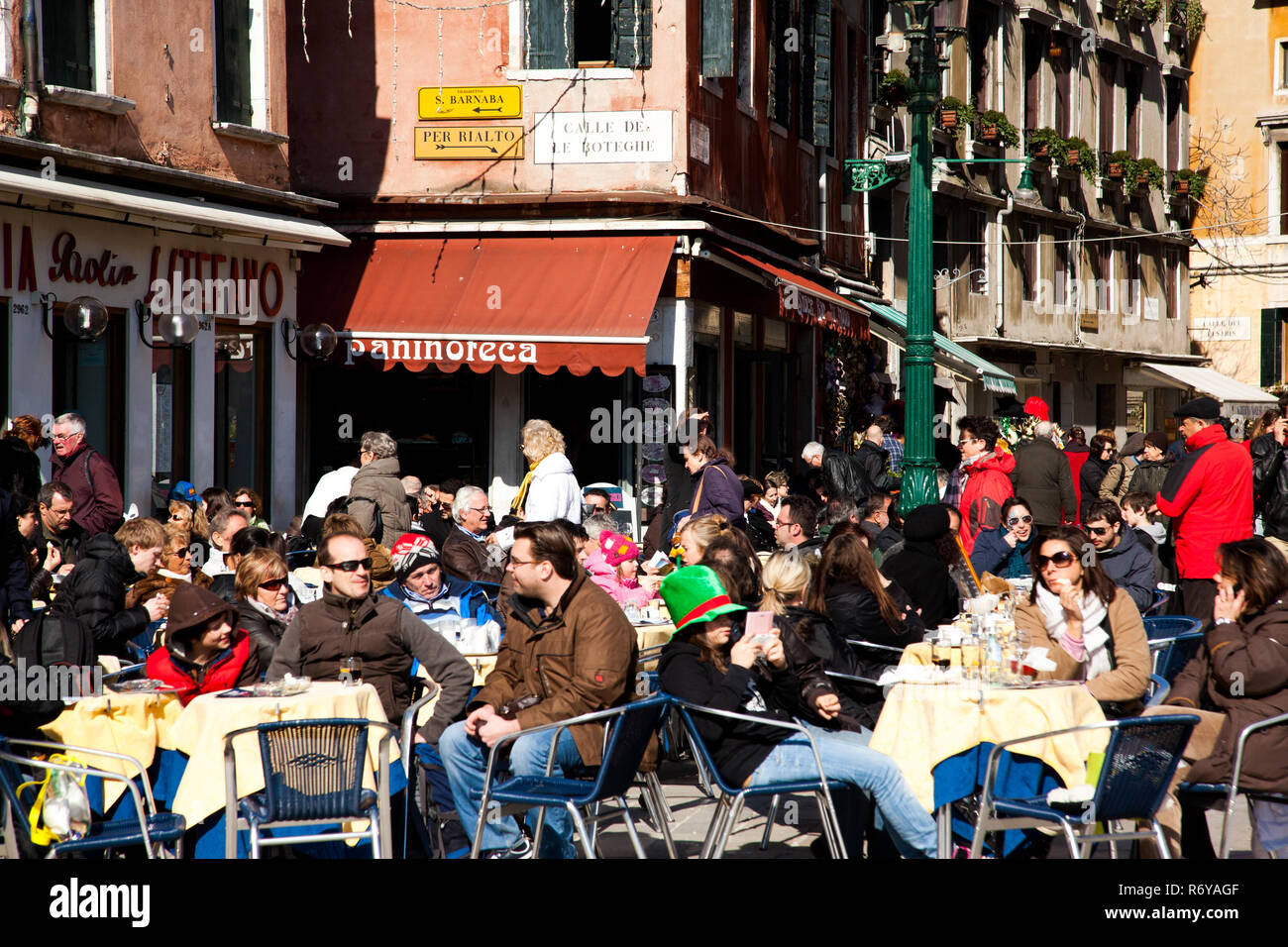 Crowds relaxing at outdoor cafes in Campo Santo Stefano during Carnivale 2011 in Venice Italy Stock Photo