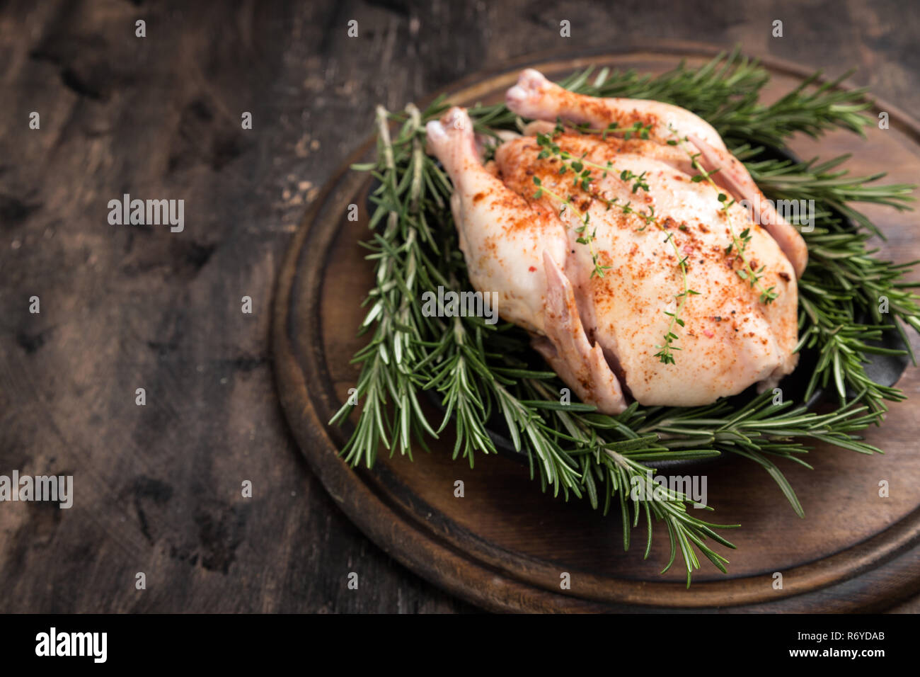 Premium Photo  Raw chicken on a cutter board with vegetables and spices