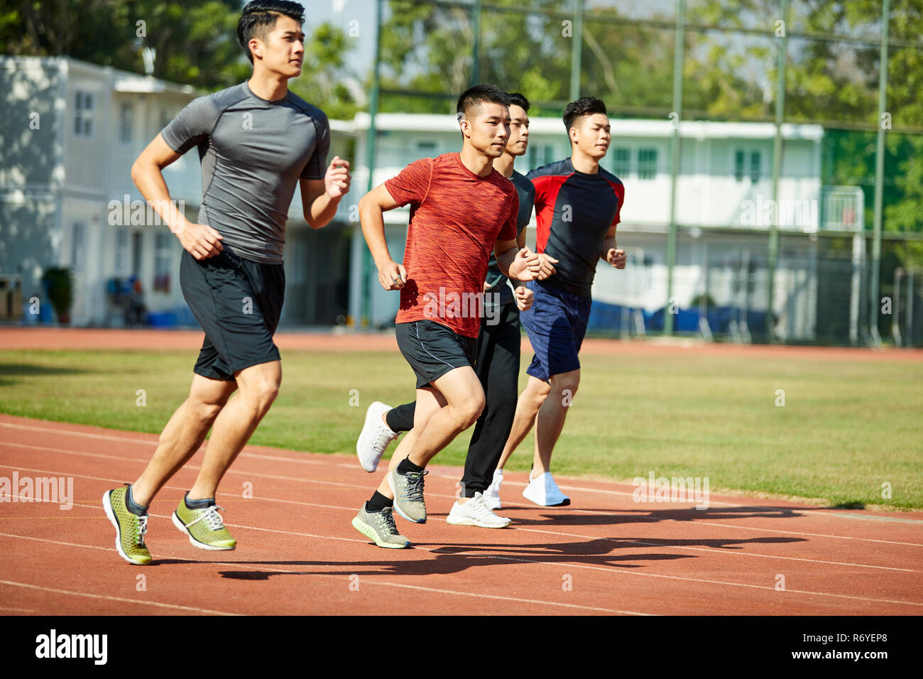 Asian Races Track four young asian track and field athletes racing competing against each ...
