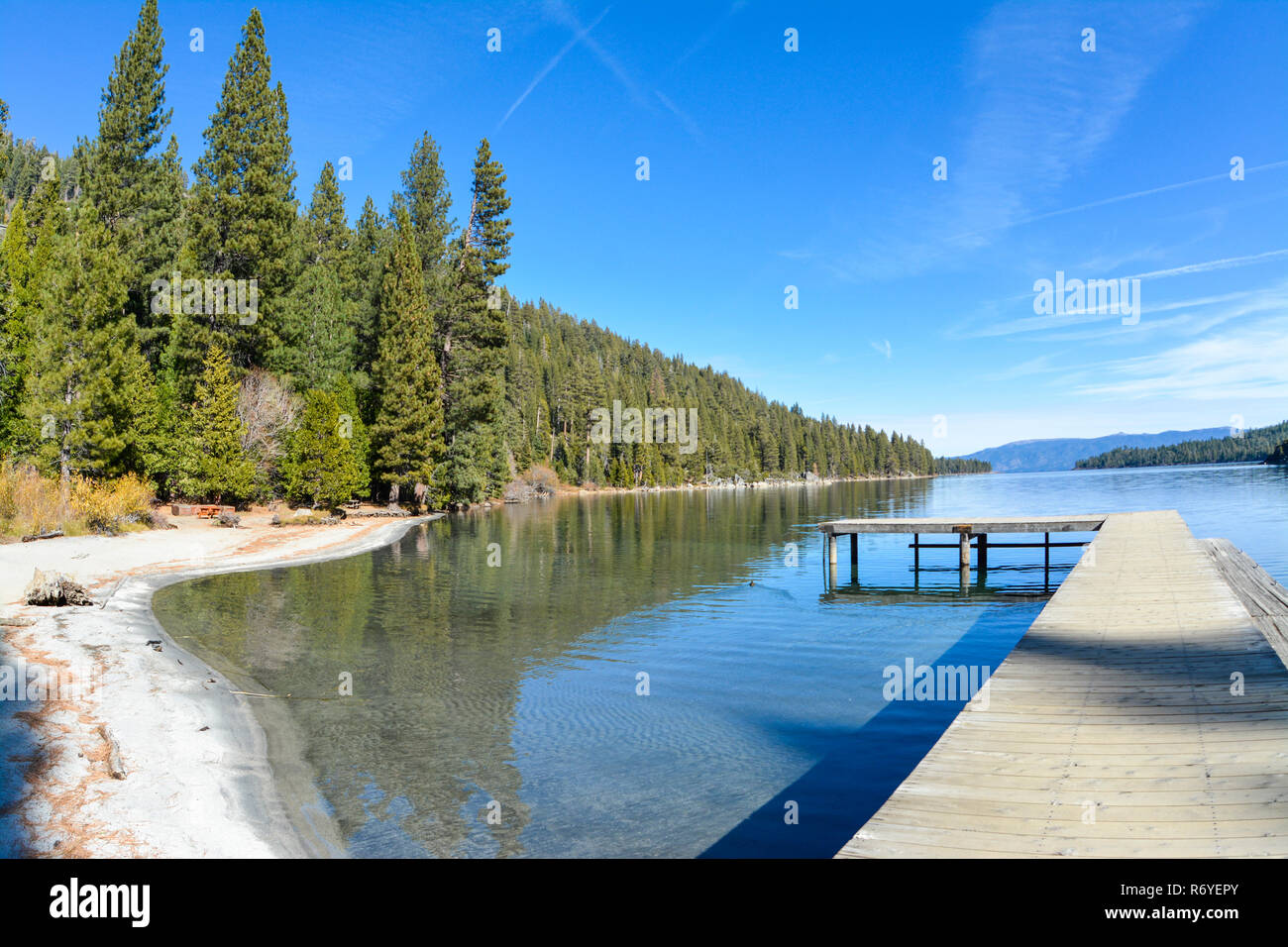 Emerald Bay, Lake Tahoe with pier on the right and pine trees in the left. Stock Photo