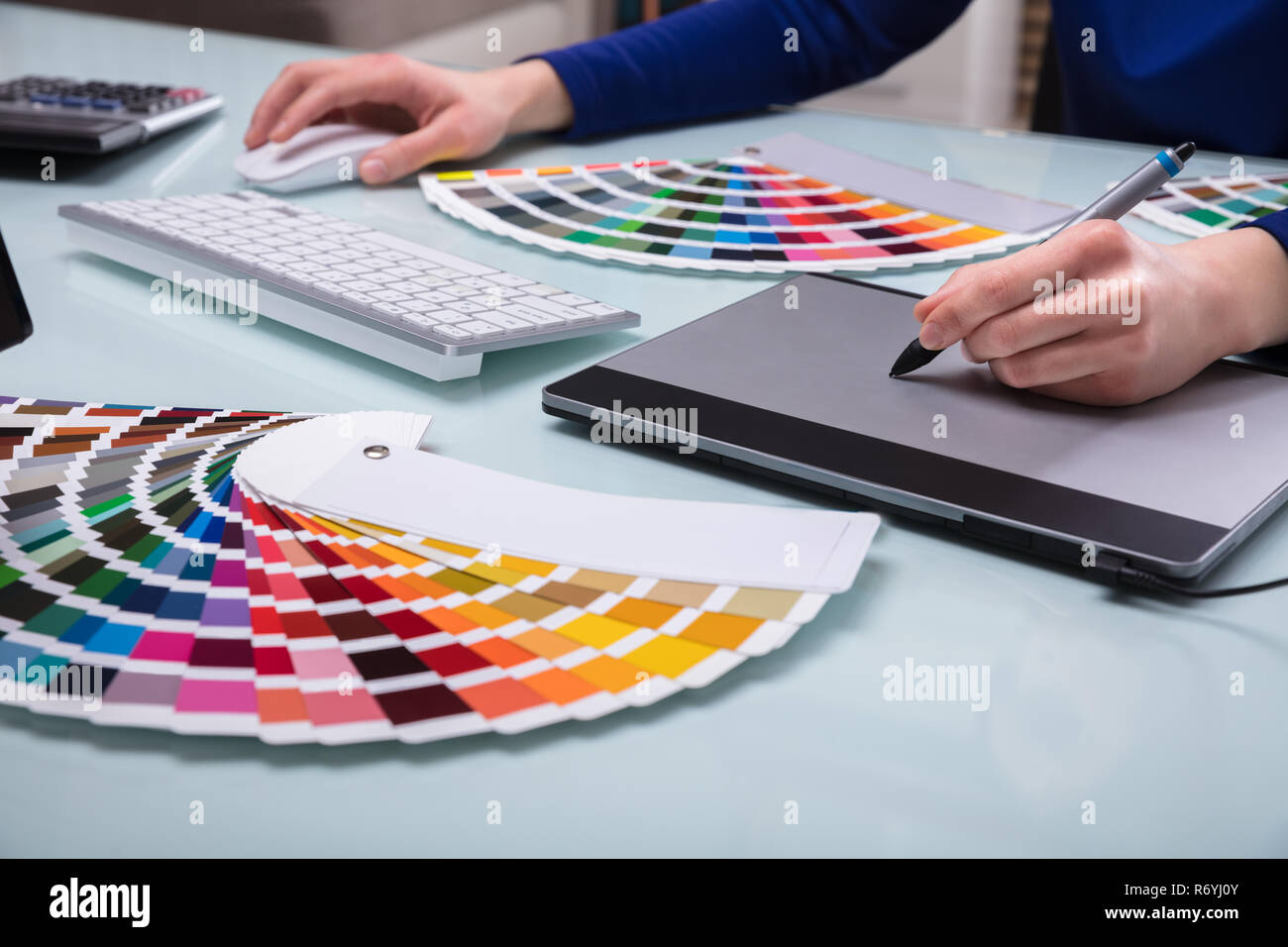 Designer's Hand Drawing On Graphic Tablet Stock Photo