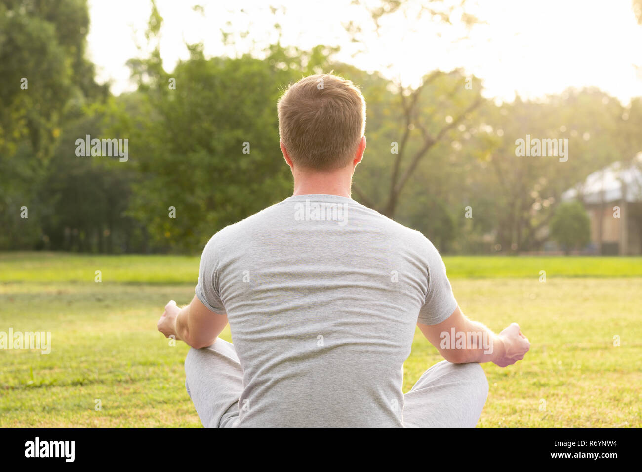 Rear view man meditating sitting hi-res stock photography and images ...