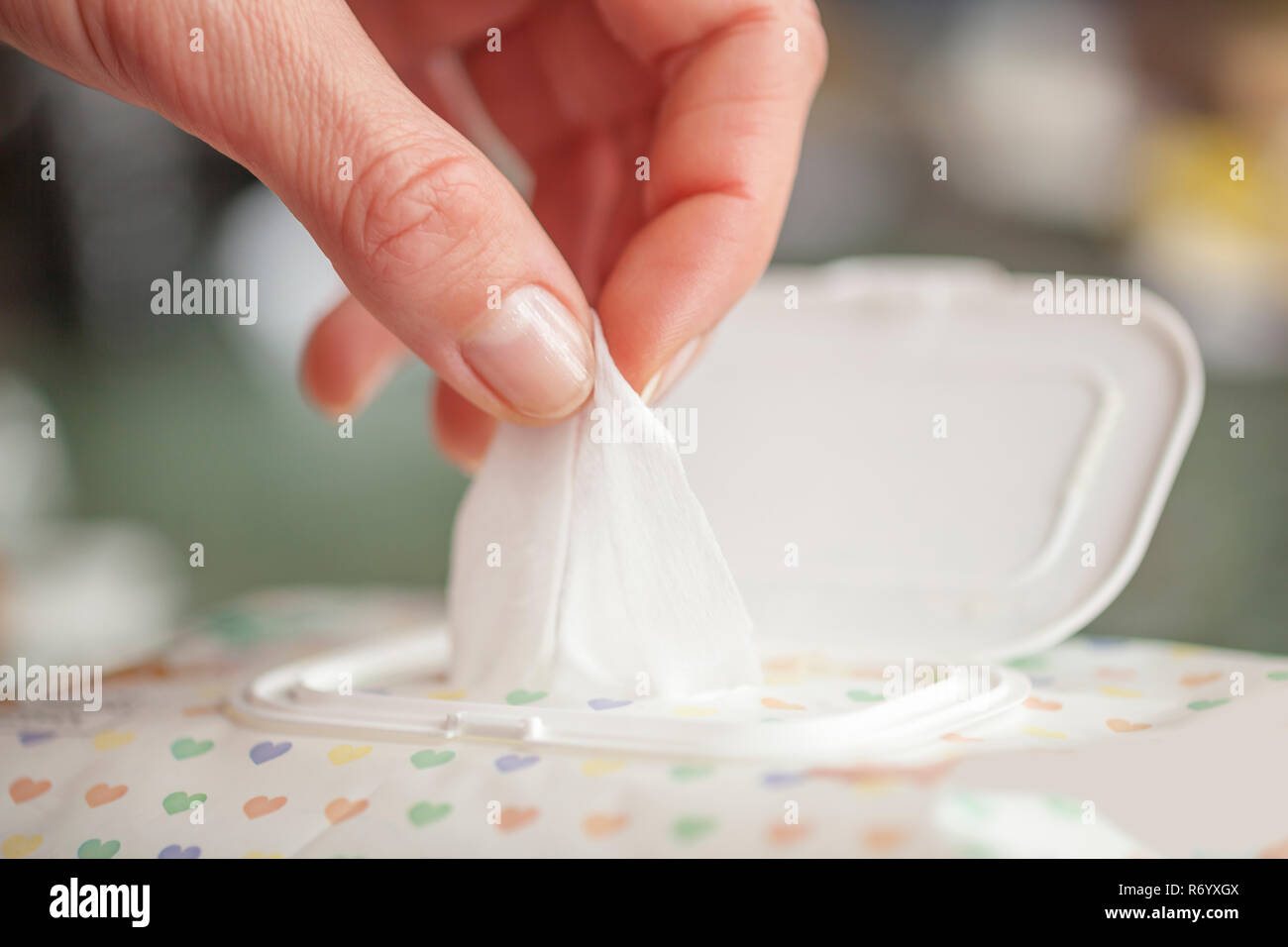 Hand picked a wet wipes in package box, Wet wipes in a woman's hand Stock Photo