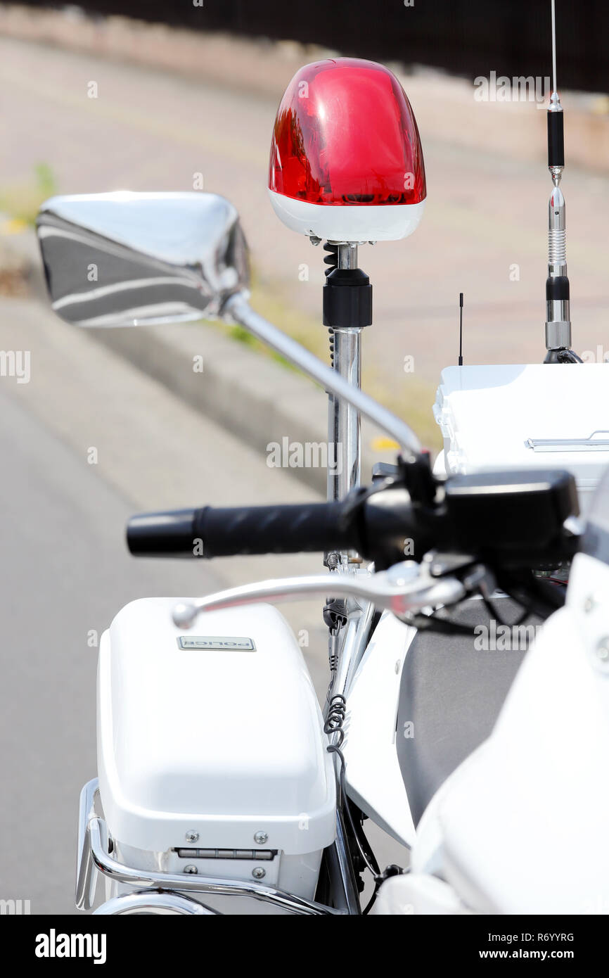 Japanese police motorcycle with red lamp on the road Stock Photo
