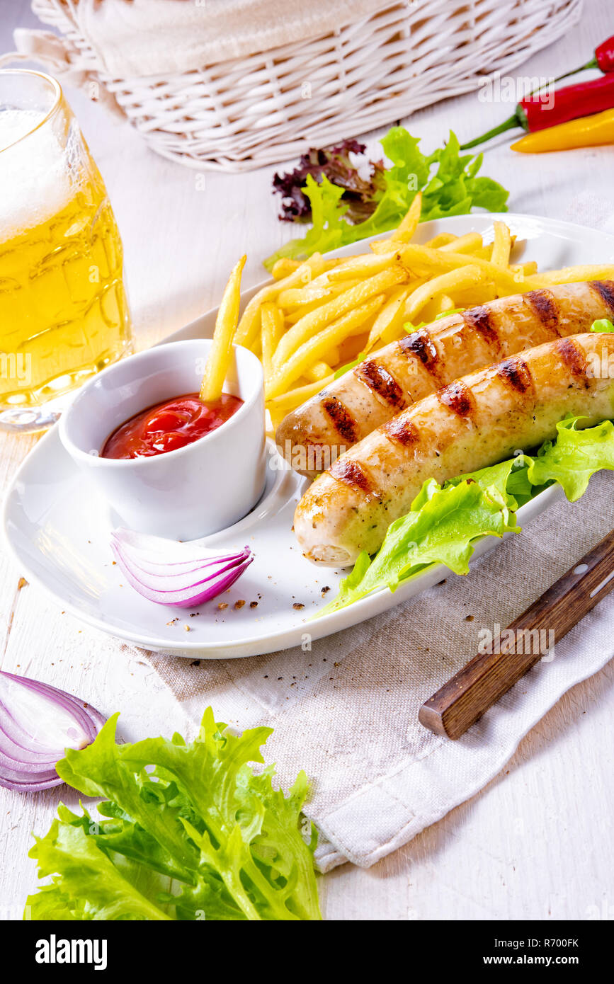 grilled sausage with chips and cold beer Stock Photo Alamy