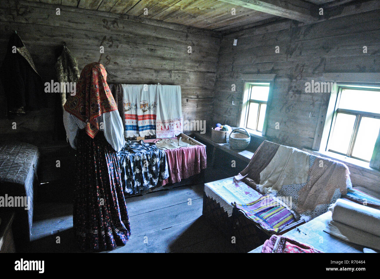 Museum of Wooden Architecture and Peasant Life - Interior of an ancient Russian wooden house, with traditional costumes. Suzdal Stock Photo